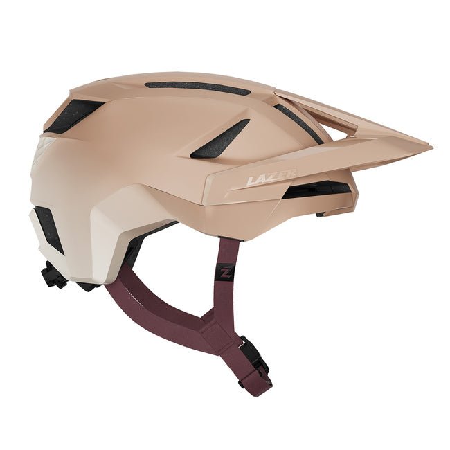 Lazer Impala Kineticore enduro helmet in matte beige – A matte beige mountain bike helmet shown in profile against a plain white background, featuring integrated ventilation cutouts, an extended sun visor, and maroon adjustable chin straps.