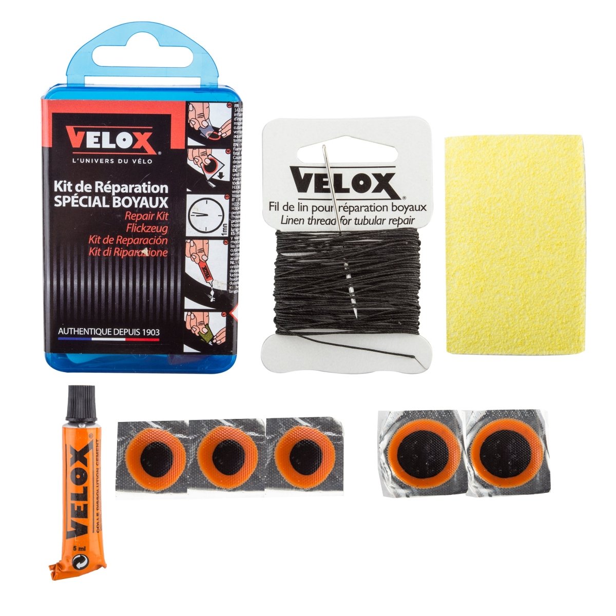 Velox tubular bicycle tire repair kit – Velox tubular tire patch kit displayed on a white background, featuring a blue case, black linen thread with a needle, rubber patches, glue tube, and sandpaper.