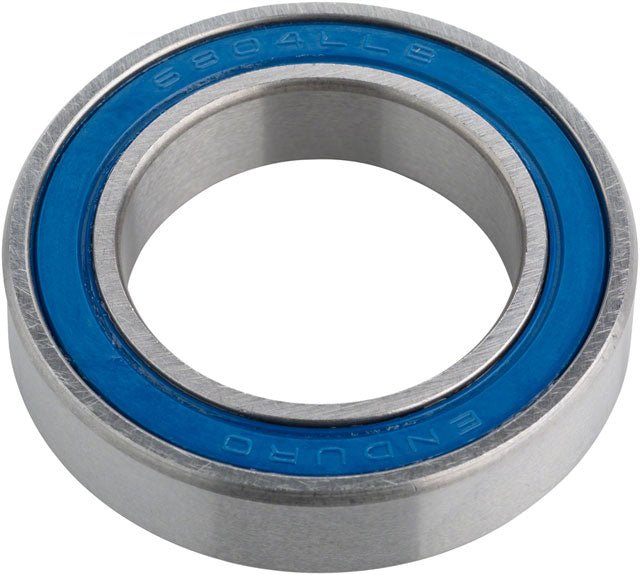 Enduro 6804 sealed cartridge bearing – A circular steel cartridge bearing angled on a white background, featuring polished silver inner and outer rings with an embossed blue rubber seal.