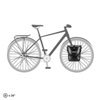 Black Ortlieb pannier on bicycle front rack – A single black Ortlieb pannier bag is mounted to the front lowrider rack of a bicycle silhouette, shown in a profile view against a white background.