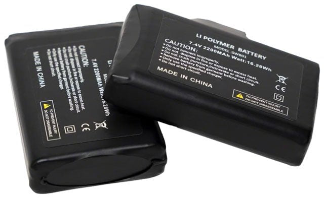 Black lithium polymer heated glove batteries – A pair of rectangular black 7.4V lithium polymer battery packs with printed technical specifications and caution text, resting against each other on a plain white background.