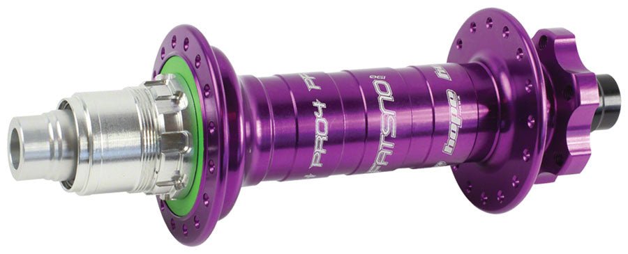 Hope Fatsno Pro 4 rear hub in purple – A purple anodized aluminum fat bike rear hub shown horizontally against a white background, featuring a silver freehub body, green seal ring, and drilled spoke flanges.