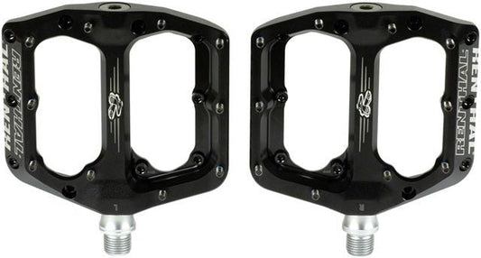 Renthal Revo-F black platform pedals – Pair of black aluminum mountain bike platform pedals shown side by side with silver threaded axles, traction pins, and white Renthal branding against a plain white background.