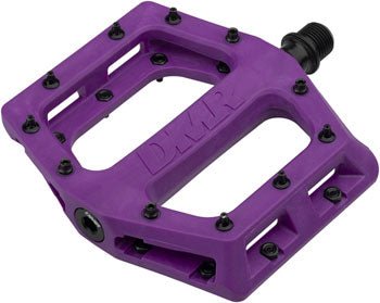 DMR V11 purple composite platform pedal – A purple composite platform bike pedal shown at an angle against a white background, featuring an embossed DMR logo, black traction pins, and a threaded spindle.