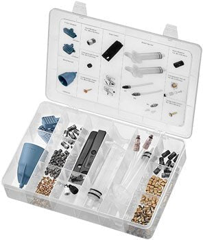 TRP hydraulic disc brake bleed kit – An open clear plastic organizer case holds hydraulic brake bleed components, including syringes, clear tubing, a blue funnel, bleed blocks, and compartments of brass and silver fittings.