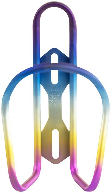 Silca Sicuro rainbow titanium bottle cage – A titanium bicycle water bottle cage features an anodized rainbow gradient shifting from purple and blue to gold and pink, isolated on a white background.