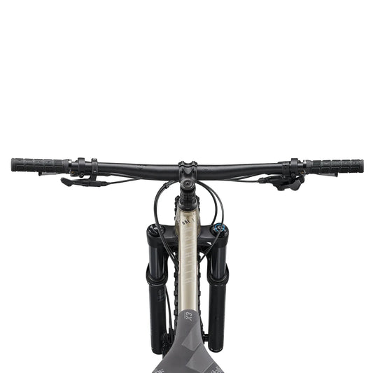 Fuji Bighorn mountain bike cockpit view – Top-down view of a hardtail mountain bike cockpit showcasing wide black handlebars, textured grips, suspension fork stanchions, and the tan top tube set against a white background.