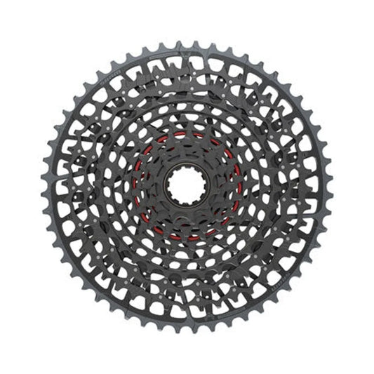 SRAM X0 Eagle 12-speed bike cassette – A front view of a matte black 12-speed bicycle cassette centered on a plain white background, showing concentric cutout cogs with a red interior ring accent.