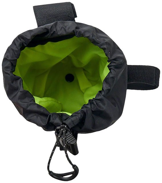 Revelate Designs Mountain Feed Bag in black – Top-down view of an open black handlebar bag, showing its bright chartreuse interior lining, drawstring closure toggle, and exterior attachment straps against a plain white background.