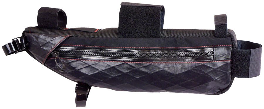 Revelate Designs black Tangle frame bag – A black bicycle frame bag shown in profile with diamond-textured lower fabric, a weatherproof zipper, red contrast stitching, and hook-and-loop attachment straps against a white background.