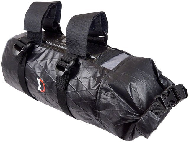 Revelate Designs Joey downtube bike bag in black – A cylindrical black ripstop bikepacking downtube bag with dual mounting straps, compression buckles, roll-top closure, and a small logo set against a white background.