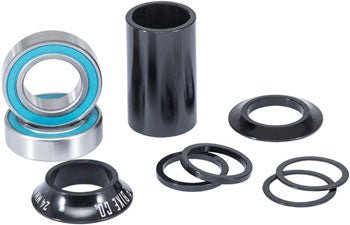 Black mid bottom bracket kit for 24mm – Sealed cartridge bearings with bright turquoise seals sit beside a black center sleeve, matching conical cone spacers, and assorted thin black washers on white.