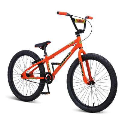 Orange SE Basher 24-inch BMX cruiser bike – Bright orange 24-inch BMX cruiser with black rims, knobby tires, high-rise handlebars with a yellow pad, and matching orange grips, displayed against a solid white background.