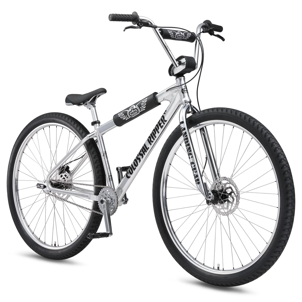 Silver SE Colossal Ripper 32 BMX cruiser – A polished silver BMX cruiser bike stands angled against a white background, featuring large 32-inch wheels, black protective frame pads, disc brakes, and wide handlebars.