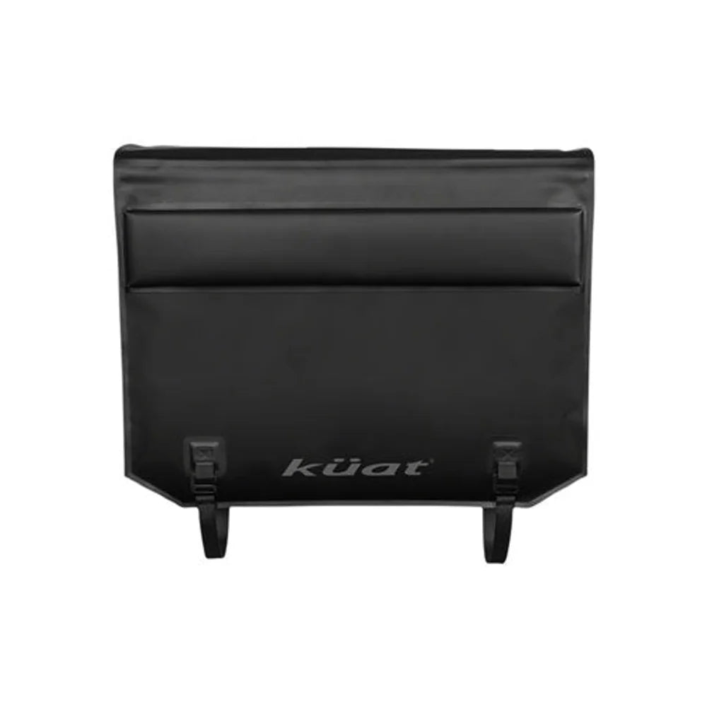 Kuat Huk black half tailgate pad – This black Kuat Huk half tailgate pad features raised horizontal padding, printed branding along the bottom edge, and dual securing straps against a white backdrop.