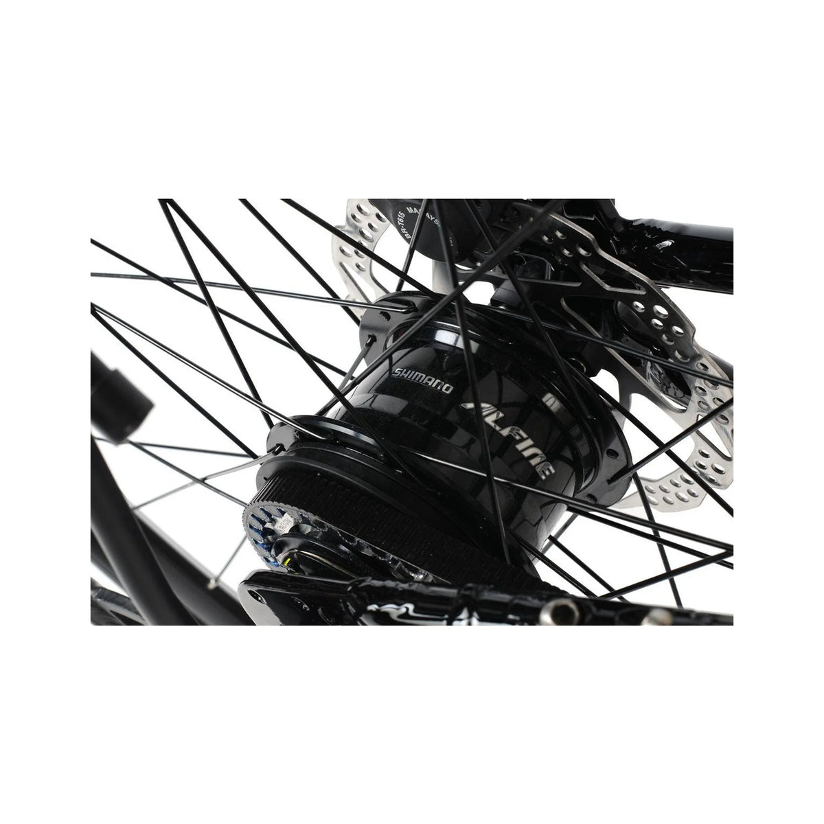 Shimano Alfine hub on folding bike – Close-up view of a black Shimano Alfine internal gear hub with belt drive cog, spoke-laced wheel, and disc brake rotor against white background.