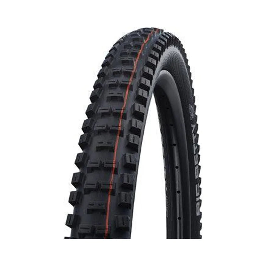 Schwalbe Big Betty mountain bike tire – A knobby black mountain bike tire mounted on a rim, featuring blocky tread lugs with an orange center line against a white studio background.