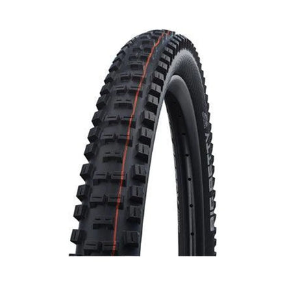 Schwalbe Big Betty mountain bike tire – A knobby black mountain bike tire mounted on a rim, featuring blocky tread lugs with an orange center line against a white studio background.
