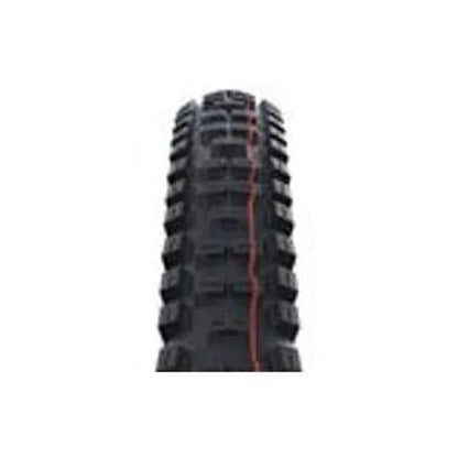 Schwalbe Big Betty mountain bike tire tread – A close-up head-on view of aggressive black mountain bike tire tread featuring square center knobs, chunky side blocks, and a vertical orange stripe running down the center against a white background.