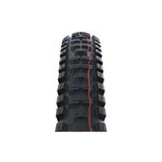 Schwalbe Big Betty mountain bike tire tread – A close-up head-on view of aggressive black mountain bike tire tread featuring square center knobs, chunky side blocks, and a vertical orange stripe running down the center against a white background.
