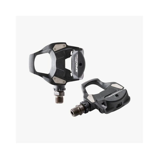 Shimano PD-RS500 SPD-SL road pedals – A pair of black composite road bike pedals with stainless steel body plates and threaded steel spindles against a plain white background.