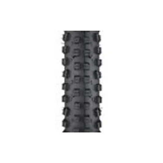 Surly Dirt Wizard knobby bike tire tread – A close-up view of the aggressive black rubber tread pattern on a mountain bike tire, featuring prominent raised center and side knobs against a plain white background.