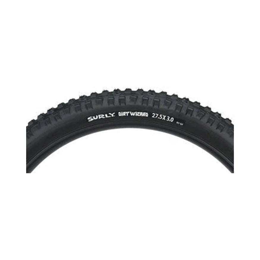 Surly Dirt Wizard tubeless bike tire – The upper curved section of a black Surly Dirt Wizard mountain bike tire features knobby tread and white sidewall branding over a plain background.